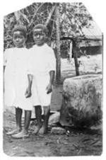 Two young girls stand by a rock. Written on verso: Fannie S. G. Clair,  Hall G. Willah.