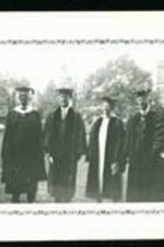 John Hope and three unidentified men and one women with academic regalia.
