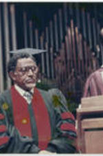 Joseph E. Lowery listens as Dr. Hugh Gloster speaks at Morehouse College's commencement ceremony.