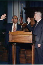 John H. Ruffin being sworn in by Governor Zell Miller. Written on verso: Judge John H. (Jack) Ruffin, Jr. being sworn in as Judge of the Courts of Appeals of Georgia by Governor Zell Miller August 24, 1994.