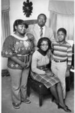 C. Eric Lincoln stands with his wife Lucy (seated)and children Less Charles and Hilary Anne.