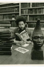 An unidentified man reads a copy of Black World in a library.