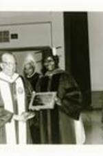 Written on verso: President Hugh M. Gloster presents 25-year plaque to Dr. Harriet Walton, Mathematics Department - Commencement - May 22, 1983.