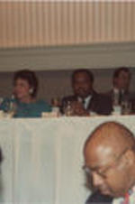 Joseph and Evelyn Lowery, Walter E. Fauntroy, Coretta Scott King, Martin Luther King, III, and others are shown seated at an event during the 30th Annual Southern Christian Leadership Conference Convention in New Orleans, Louisiana.