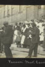 View of a group of people standing outside of a building attending the farmer's short course.