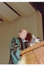 President Hugh Gloster speaking at podium.