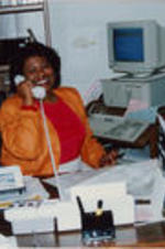 An unidentified woman is shown posing for a picture in an office at the SCLC/W.O.M.E.N. Learning Center.