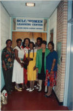 Evelyn G. Lowery is shown posing with a group of women in front of the entrance to the SCLC/W.O.M.E.N. Learning Center.