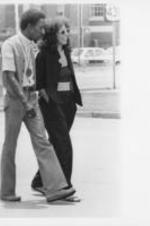 Southern Christian Leadership Conference (SCLC) staff member E. Randel T. Osburn walks with an unidentified woman along a street in Eufaula, Alabama.