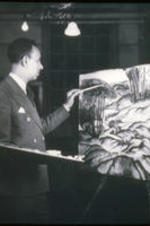 A slide featuring a photo of Hale Woodruff painting a landscape.