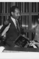 Evelyn G. Lowery is shown presenting the Drum Major for Justice Special Moral Imperatives Award to Emanuel Cleaver during the 12th Annual Drum Major for Justice Awards dinner. Written on verso: 4-6-91