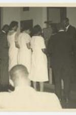 Indoor view of men and women at certificate presentation. Written on verso: Presenting lay speaker certificate at the Tennessee Annual Conference Nashville, Tenn. June 1963.