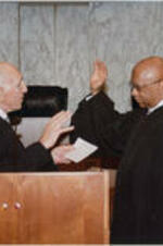 Judge John H. Ruffin, Jr. being sworn-in as Chief Judge of Court of Appeals of Georgia by Judge Anthony A. Alaims. Written on verso: Judge John H. Ruffin, Jr. being sworn-in as Chief Judge, Court of Appeals of Georgia by Judge Anthony A. Alaims, U.S. District Court, Southern Districts of Georgia January 5, 2005