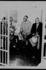 Written on recto: Negro leaders jailed for bus ride. Sitting behind bars in city jail today are five Negro clergymen arrested on charges that they violated Georgia's segregation laws. At the right is their leader, the Rev. William Holmes Borders. They were in jail pending the posting of $1,00 bond each. The arrests resulted from a group of some 20 Negro ministers occupying public bus seats up front which are customarily reserved for White customers.