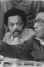 Southern Christian Leadership Conference President Joseph E. Lowery and Reverend Jesse Jackson are shown speaking at a Pilgrimage to Washington press conference in Tuskegee, Alabama. Written on verso: Press Conf. April 19, '82