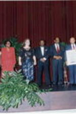 A group stands onstage holding awards at the Atlanta Student Movement 20th anniversary event.