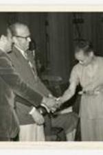 Written on verso: President Gloster and Mr. Young welcome surprise guest Ms. Eartha Kitt Oct. 23, 1979.