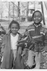 Two children smile for the camera. Written on verso: Gammon Theological Seminary, 1958. Children of student families (L to R), Willamena Meekins and Josephine Bronson.