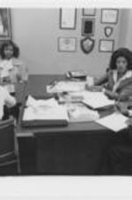 Vivian Malone Jones talks with a man and women in her office.