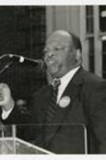 John Lewis stands at the podium outdoors at a homecoming activity.