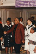 Joseph and Evelyn Lowery are shown holding hands and singing with generations of women during a SCLC/W.O.M.E.N. Bridging the Gap: Girls to Women Mentoring Program event.