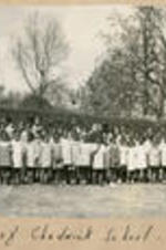 A group of Chadwick School pupils stand outside in a yard.
