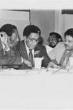 Dick Gregory, Joseph E. Lowery, and an unidentified man are shown sitting together during the 5th Annual Southern Christian Leadership Conference Alabama State Chapter Convention in Tuscaloosa, Alabama.