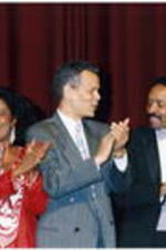 Julian Bond claps with others onstage at the Atlanta Student Movement 20th anniversary event.