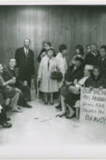 Protesters are shown in a group photo at Logan Airport upon their return from Florida where several of them, including Mary Peabody, were arrested and jailed for their sit-in efforts. Written on verso: Copy for use of Dr. King.