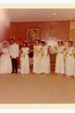 Wedding photo of the bride, groom, and bridesmaids. Written on verso: Members of Wedding Party. Wedding of Beth Chandler Theodore John Warren Jr.