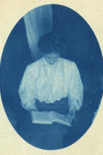 Mrs. Lugenia Burns Hope reading a book indoors.