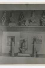 View of a display case of wooden lamps with Greek fraternity and sorority letters, and photographs.