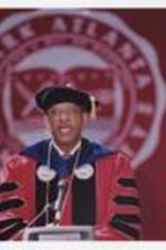 Dr. Thomas W. Cole stands at the podium at commencement.