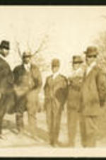 Five unidentified men wearing hats.