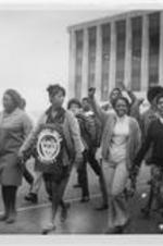 LeMoyne-Owen College students are shown marching with protest signs in Memphis, Tennessee.