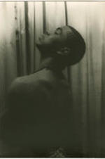 Portrait of Alvin Ailey looking upwards. Written on verso: Alvin Ailey; Photograph by Carl Van Vechten; 146 Central Park West; Cannot be reproduced without permission; March 22, 1955.