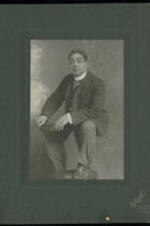 Portrait of Fred Douglas, famous comedian with the Octoroon Company and Reese Brothers, with a chair.