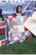 Attendees at the Global Peace Festival in Washington, D.C. display quilts.