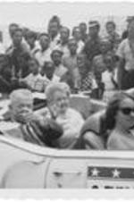 Atlanta city Alderman, Everett Millican, points from a parade car in WSB's Fourth of July Parade. Written on accompanying document: Ald. Everett Millican Running for Mayor.