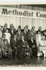 Group portrait of men and women on a stage. Written on recto: Twelfth World Methodist Conference Denver Colo. Aug. 16- 1971.