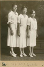 Three young women pose for a portrait. Written on recto: High school graduates.