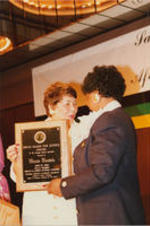Evelyn G. Lowery is shown presenting a Drum Major for Justice Award in the Struggle Against Apartheid to Winnie Mandela during the "A Salute to South African Women" event presented by SCLC/W.O.M.E.N.