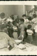 Unidentified children and adult attendees at an event.