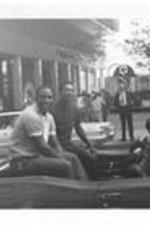 Rico Carty and Gil Garrido ride on a car in a Braves Pennant Rally parade. Written on accompanying document: Braves Pennant Rally Rico Carty and Gil Garrido.