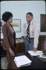 Dr. Vivian Wilson Henderson, president of Clark College, and an unidentified woman in an office.