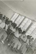 A teacher and students in a classroom.