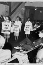 Three women wear signs in protest saying, "Don't Buy Segregation" and "Don't Buy Here"  during demonstration in Atlanta.