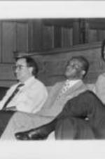James G. Abourezk, Dr. Major J. Jones, and Randall Robinson are shown sitting during a panel discussion that took place at the 23rd Annual Southern Christian Leadership Conference Convention. Written on verso: World Community and National Survival - L to R Senator James G. Abourezk, Former U.S. Senator from S. Dakota, Dr. Major J. Jones, Treasurer, SCLC, Moderator Randall Robinson, Director, Trans-Africa.