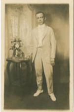 Portrait of Irvin McDuffie standing next to a table.