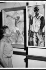 An unidentified man admires artwork at the 16th annual art exhibition.